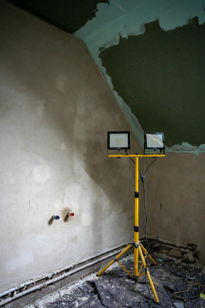 A construction site with lighting and new plaster.